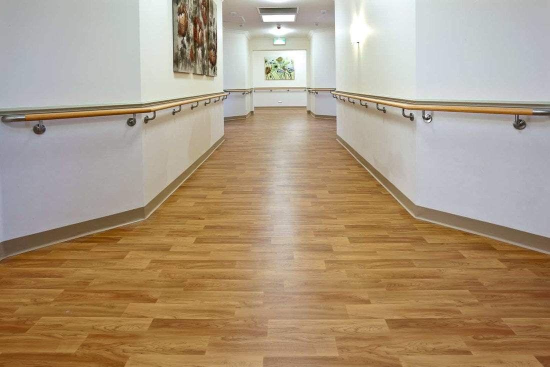 Accessible hallway with handrails, wood floors, and artwork.