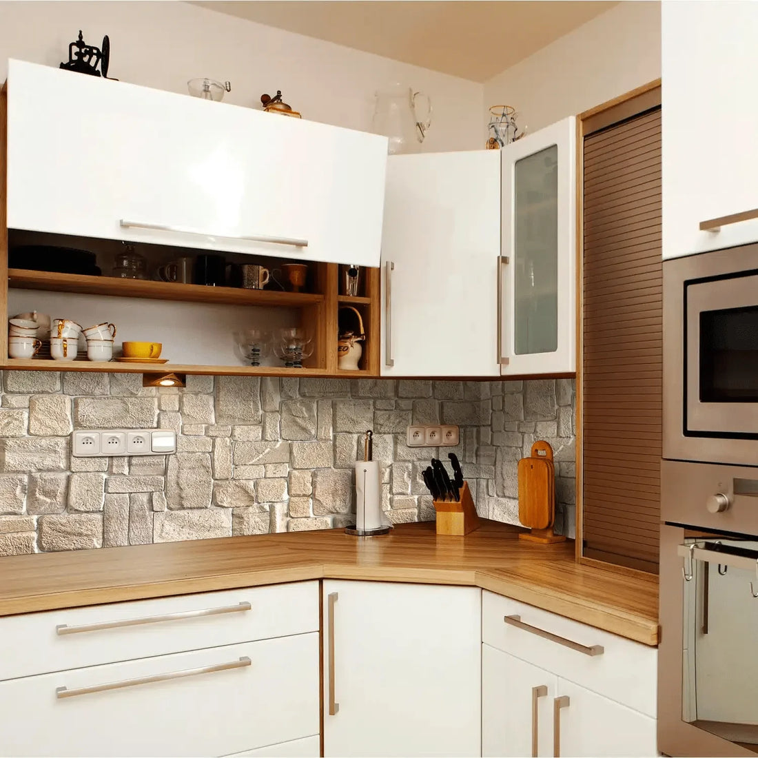 White kitchen with wooden countertops and stone backsplash