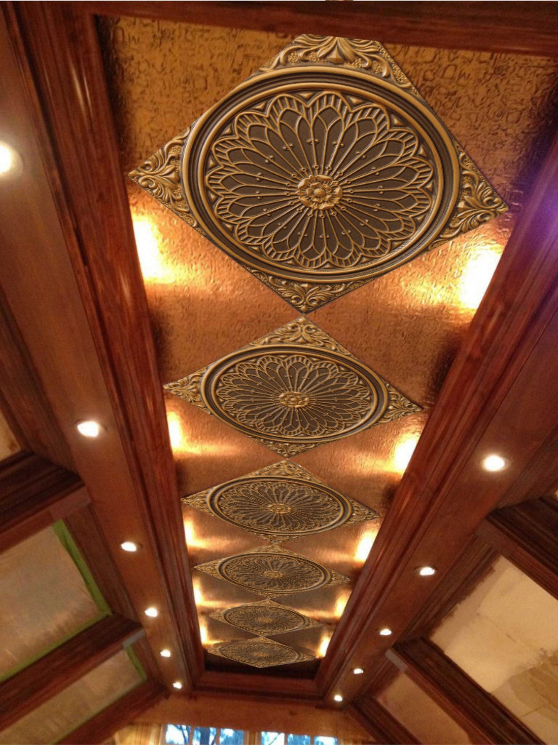 Decorative ceiling tile with intricate designs and lights.