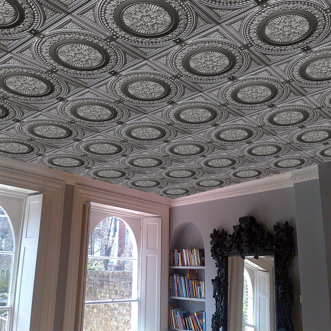 Living room with large mirror, bookshelf, and vinyl ceiling tile.