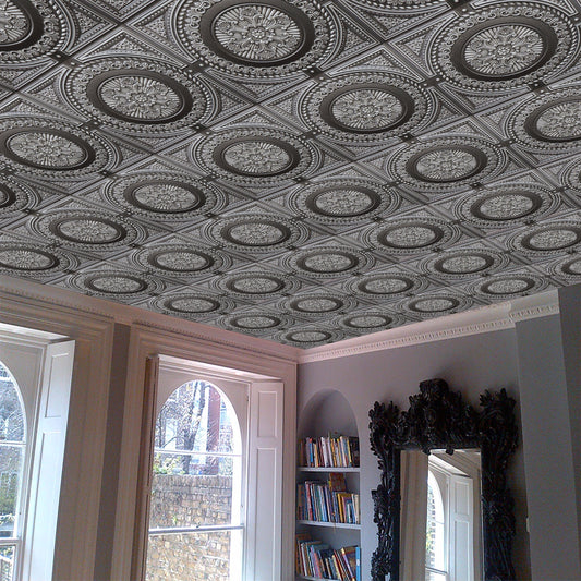 Living room with large mirror, bookshelf, and vinyl ceiling tile.