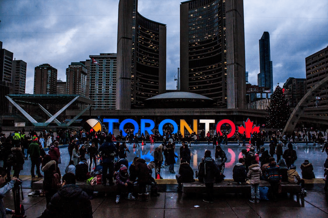 people gathered around toronto sign