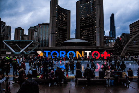 people gathered around toronto sign