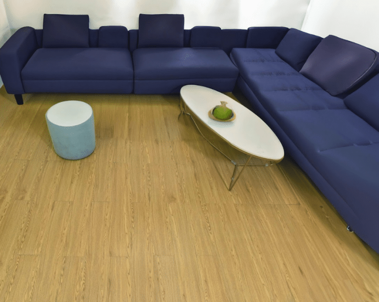 living room with deep blue sofa and wood floors