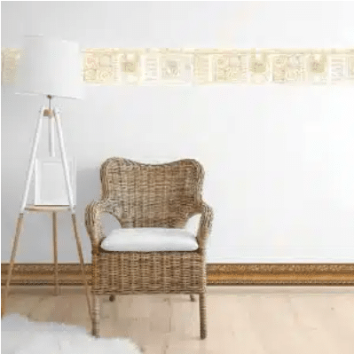 rattan chair and lamp against wall with wallpaper borders